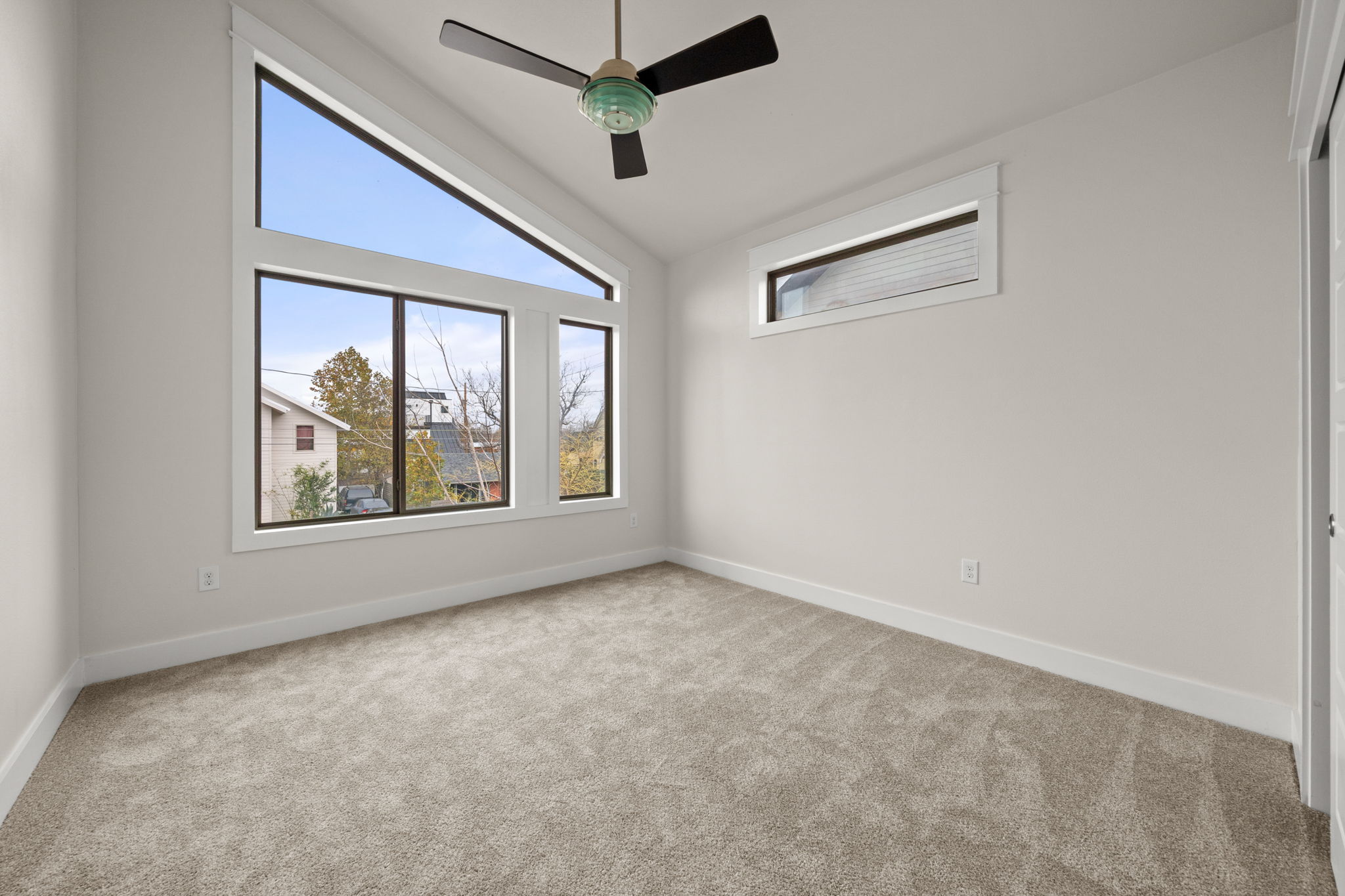 1160 Nickols Avenue, Unit A Austin, TX 78721 - Photo 10 of 40 Spare room with vaulted ceiling, light carpet, and a ceiling fan