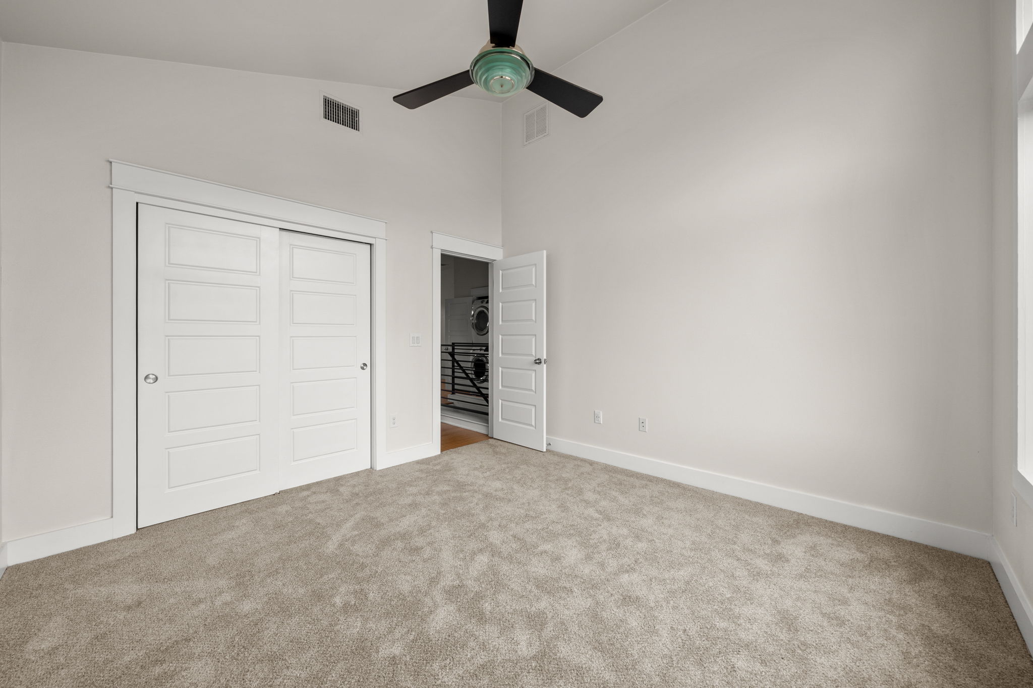 1160 Nickols Avenue, Unit A Austin, TX 78721 - Photo 12 of 40 Unfurnished bedroom featuring a closet, high vaulted ceiling, a ceiling fan, and light colored carpet
