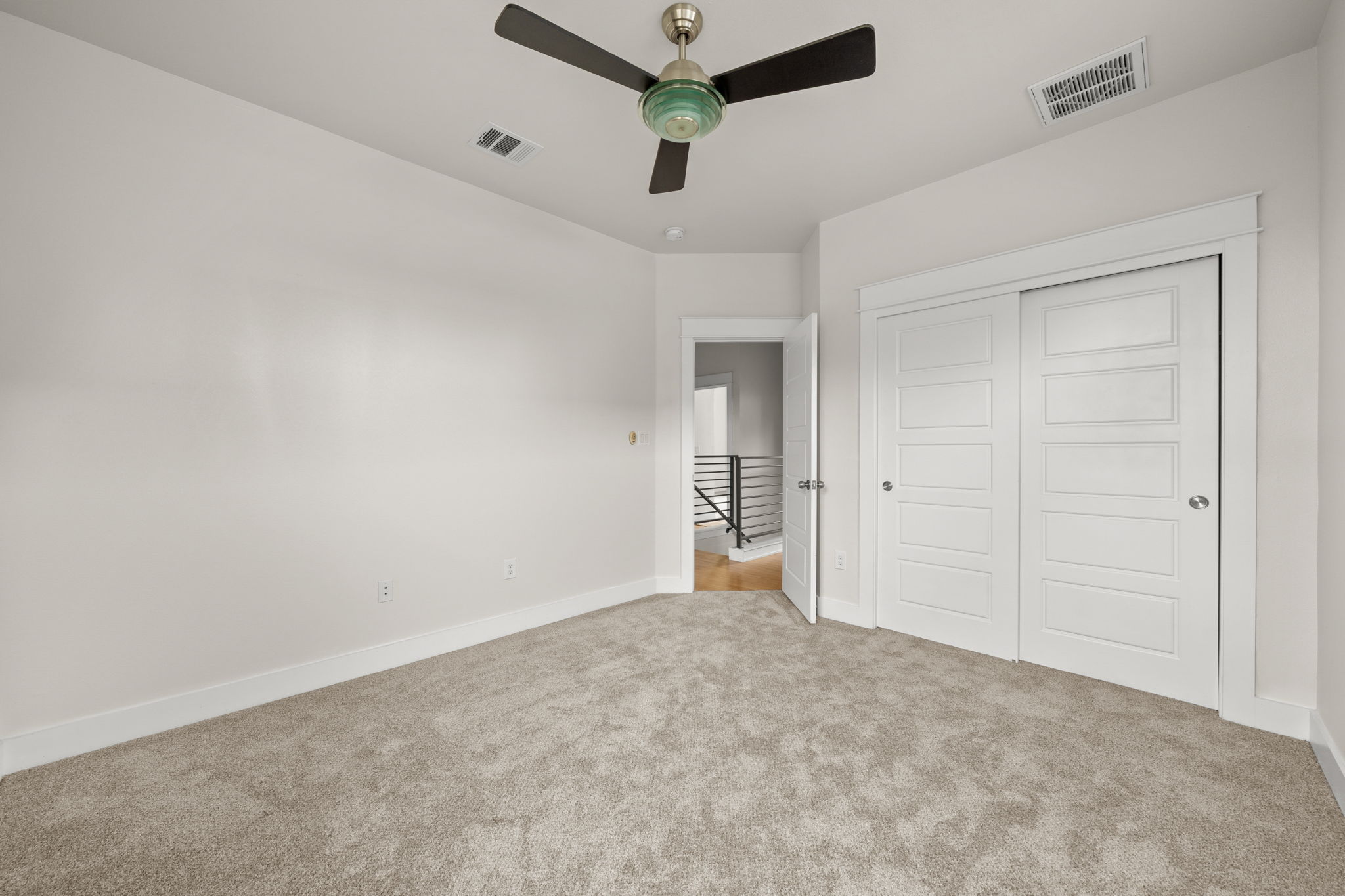 1160 Nickols Avenue, Unit A Austin, TX 78721 - Photo 16 of 40 Unfurnished bedroom featuring a closet, light colored carpet, and ceiling fan