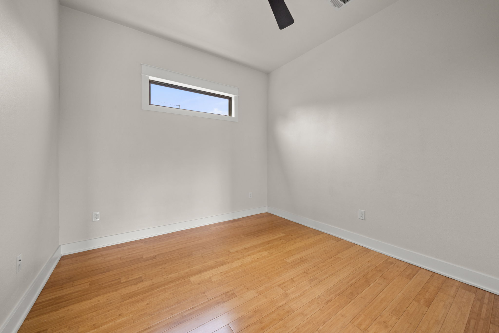 1160 Nickols Avenue, Unit A Austin, TX 78721 - Photo 18 of 40 Unfurnished room with light wood-type flooring and ceiling fan