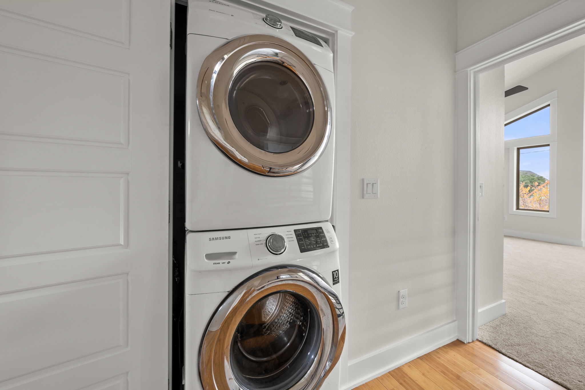 1160 Nickols Avenue, Unit A Austin, TX 78721 - Photo 20 of 40 Laundry area with estacked washer and dryer and light wood-style flooring