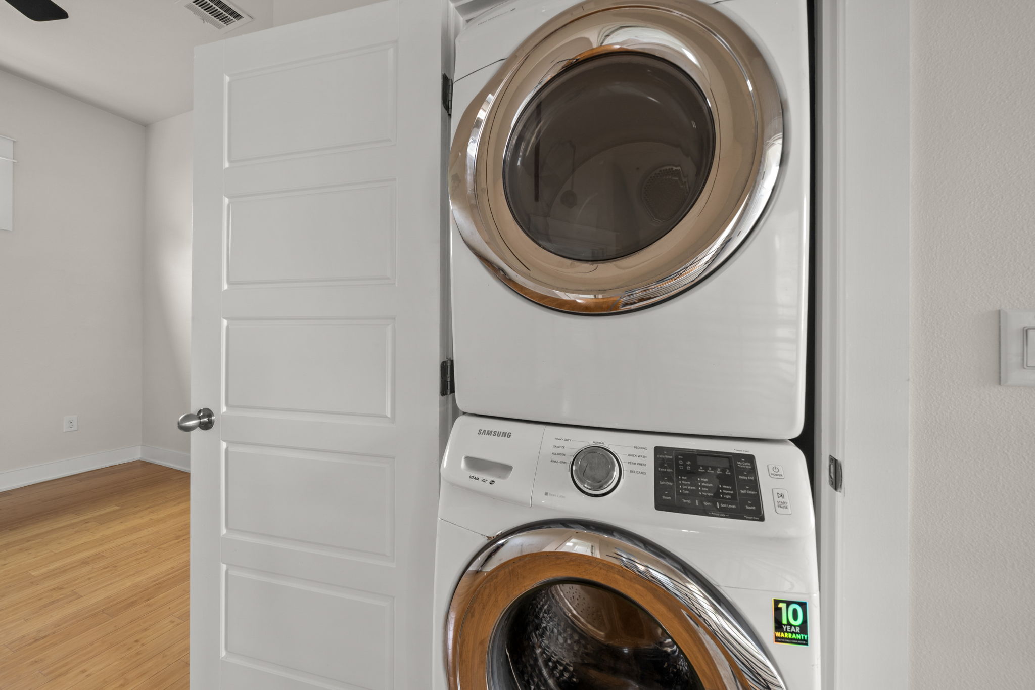 1160 Nickols Avenue, Unit A Austin, TX 78721 - Photo 21 of 40 Washroom featuring stacked washer / drying machine and wood finished floors