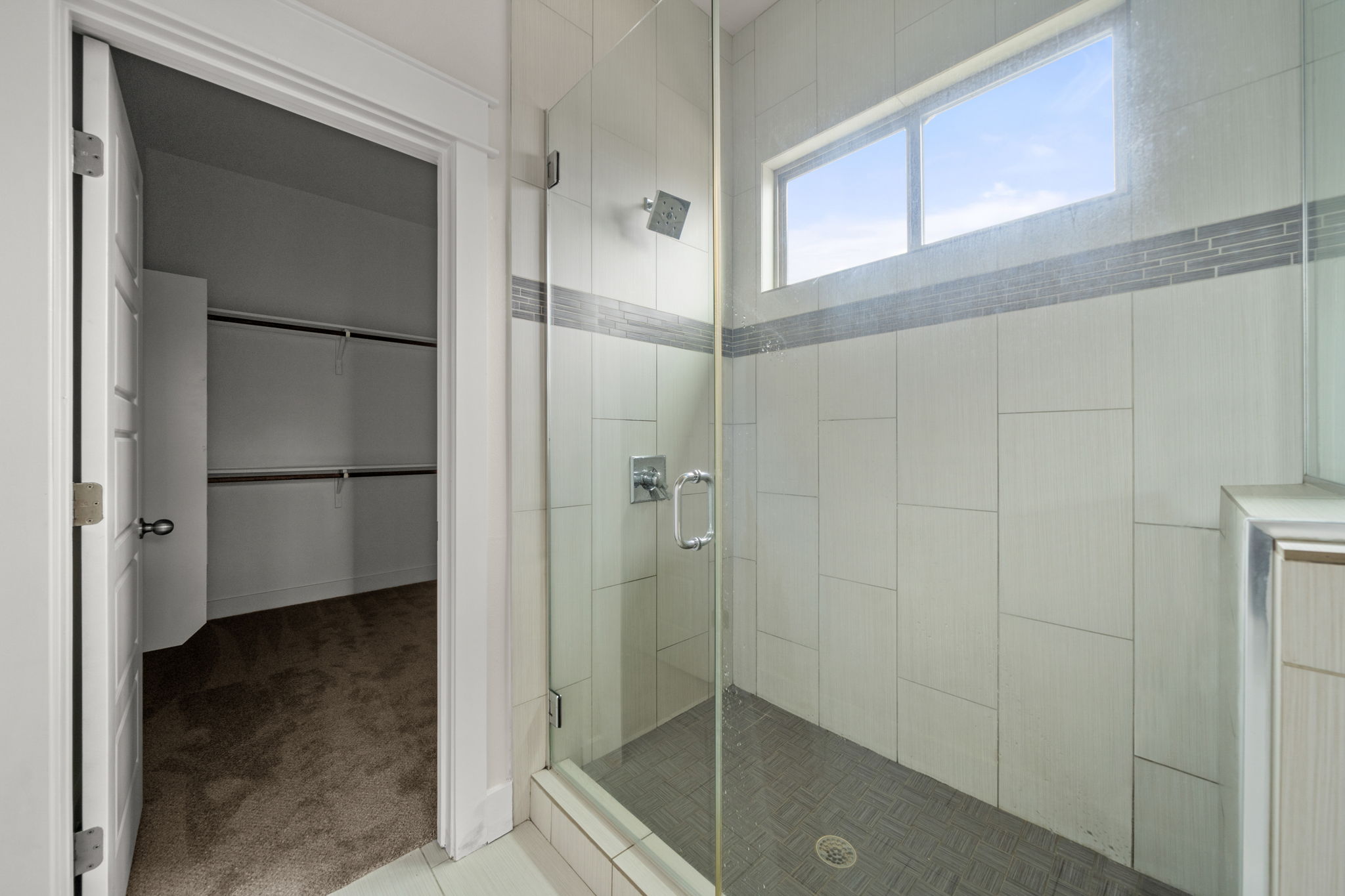 1160 Nickols Avenue, Unit A Austin, TX 78721 - Photo 28 of 40 Bathroom with carpet, a shower stall, a walk in closet, and tile patterned floors