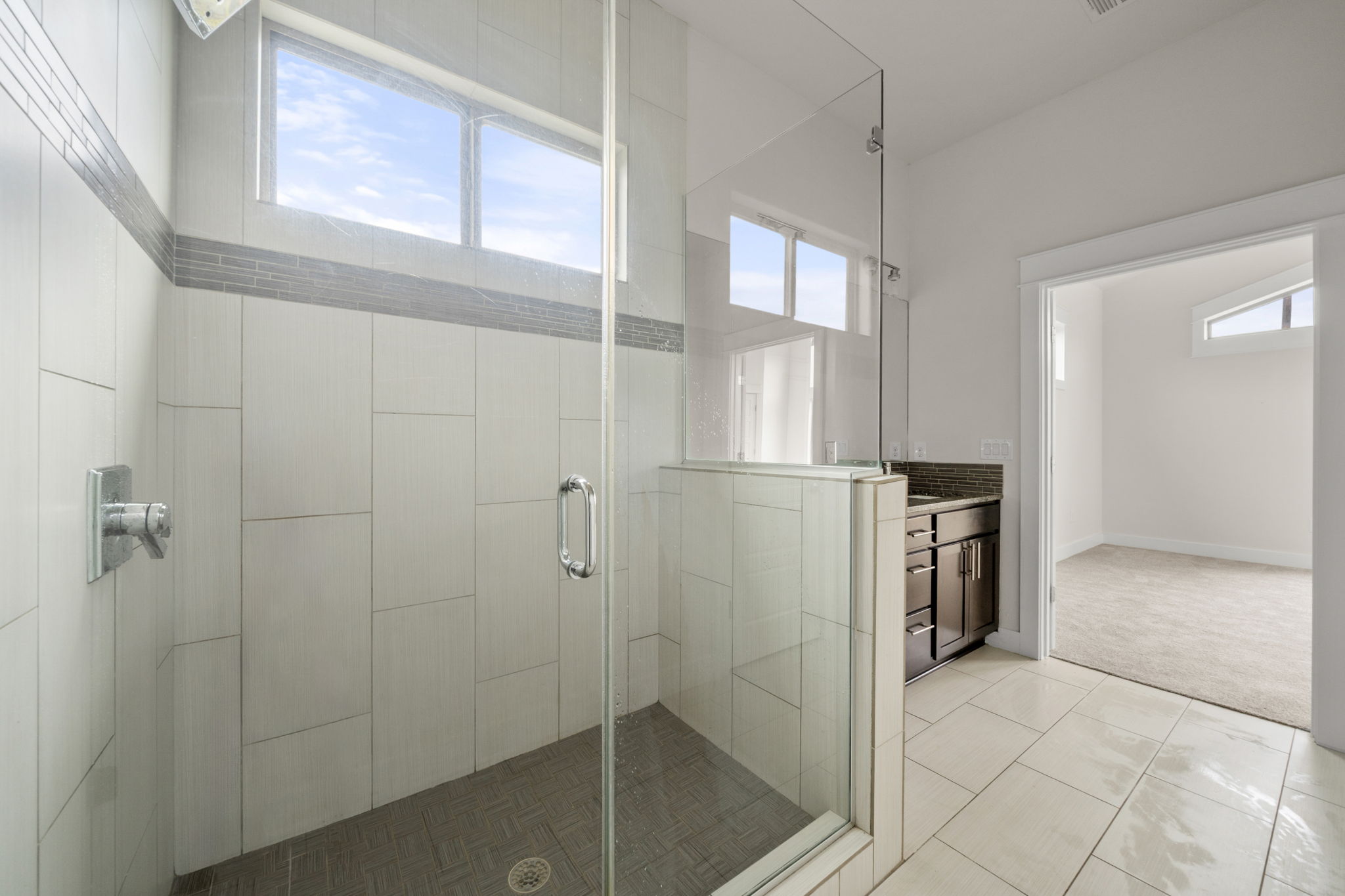 1160 Nickols Avenue, Unit A Austin, TX 78721 - Photo 29 of 40 Full bath with vanity, a stall shower, light colored carpet, and light tile patterned floors