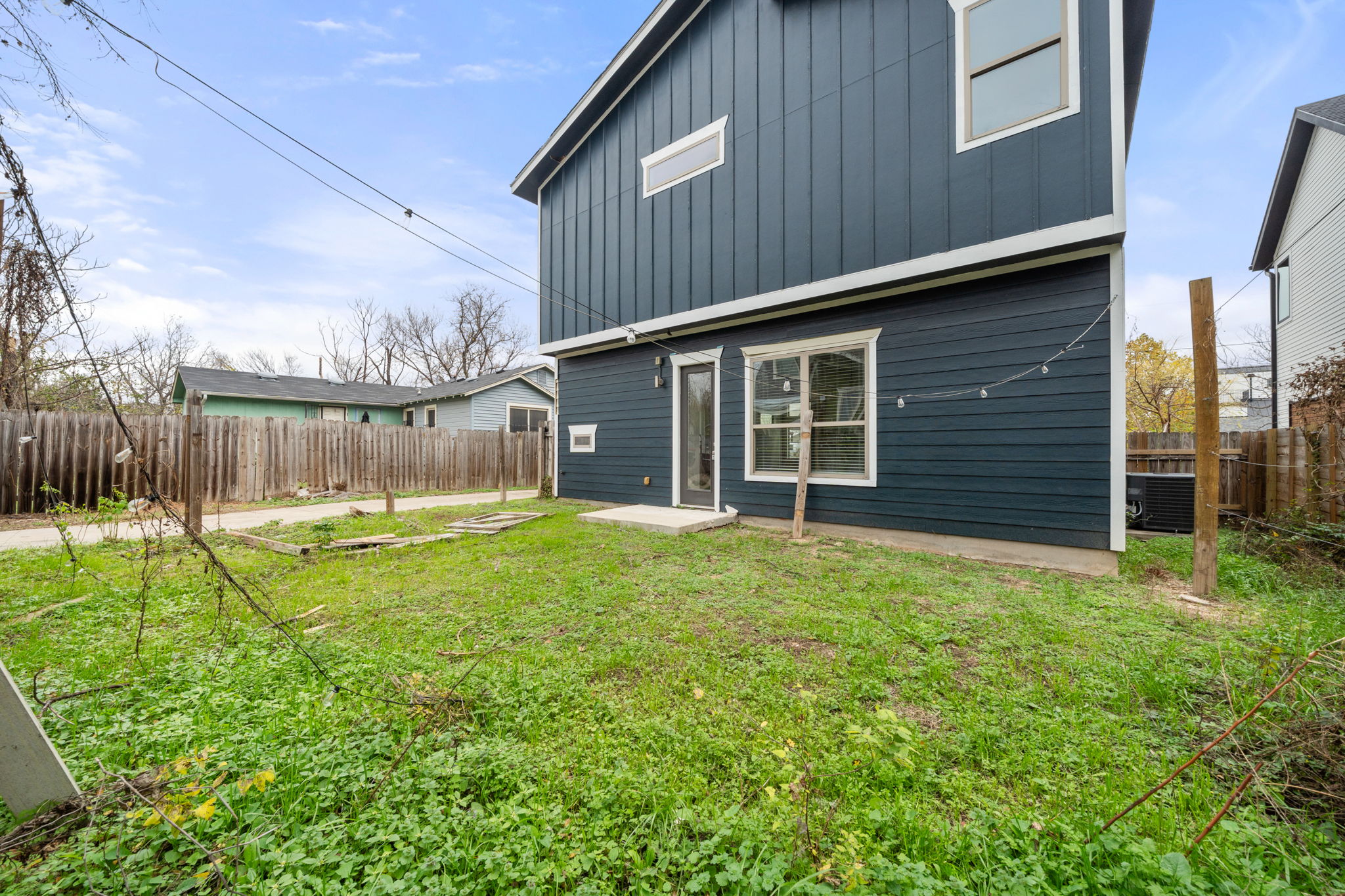 1160 Nickols Avenue, Unit A Austin, TX 78721 - Photo 32 of 40 Back of property with board and batten siding and a fenced backyard