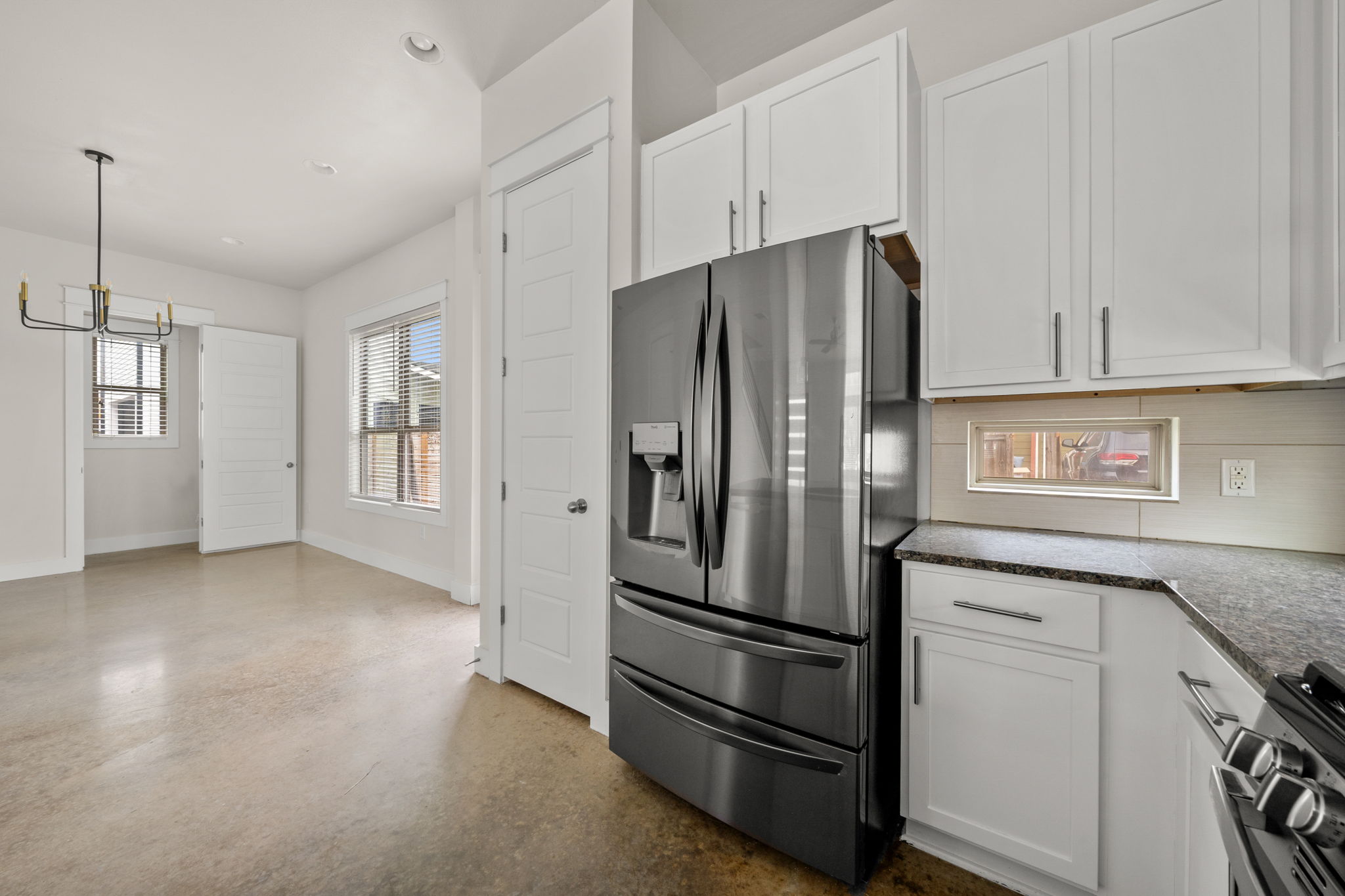 1160 Nickols Avenue, Unit A Austin, TX 78721 - Photo 3 of 40 Kitchen featuring appliances with stainless steel finishes, white cabinets, pendant lighting, backsplash, and recessed lighting