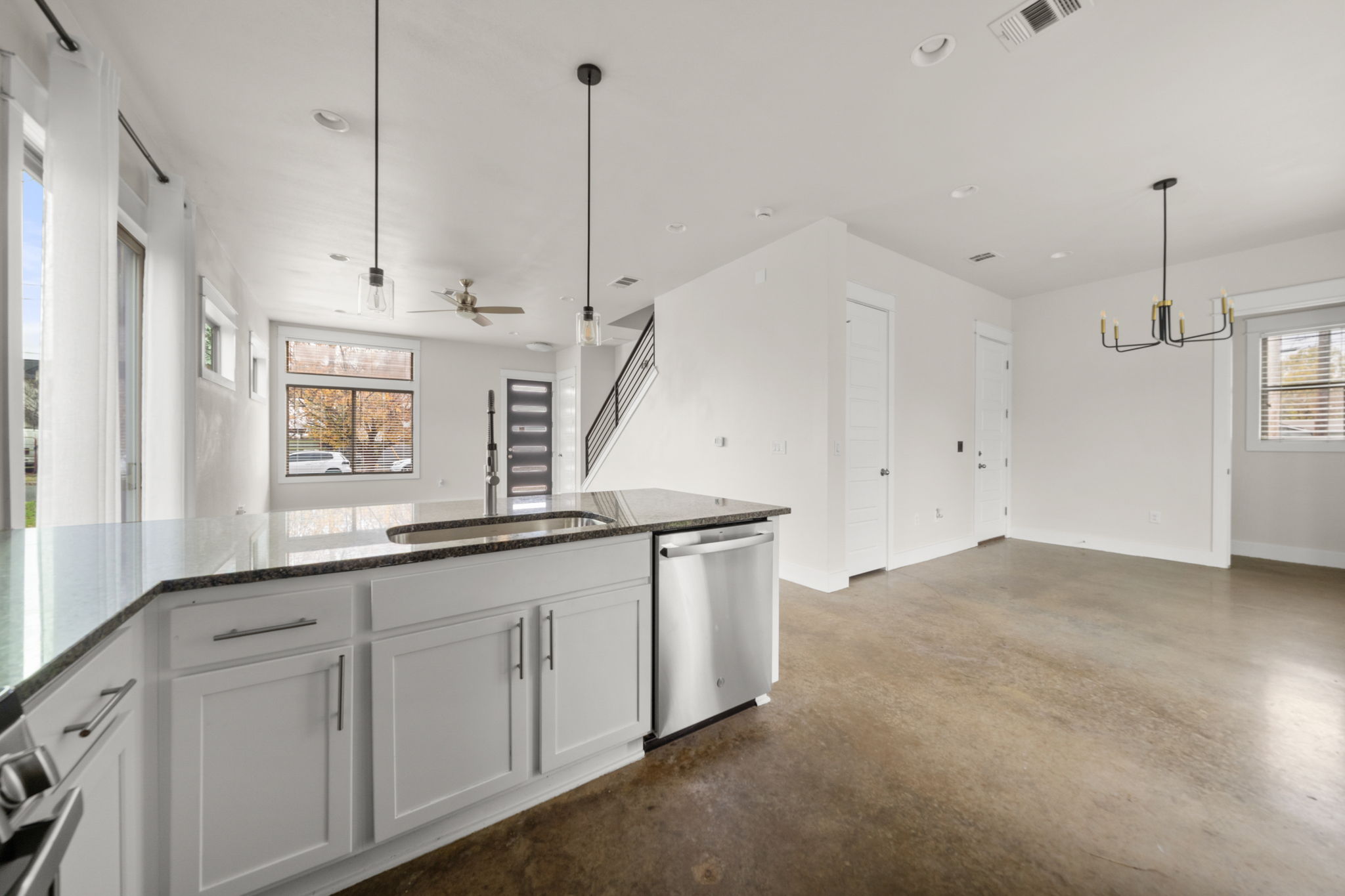 1160 Nickols Avenue, Unit A Austin, TX 78721 - Photo 40 of 40 Kitchen with open floor plan, dark stone countertops, white cabinets, and recessed lighting
