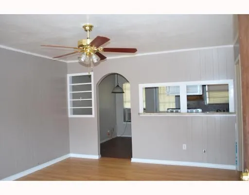 a view of a living room with a ceiling fan