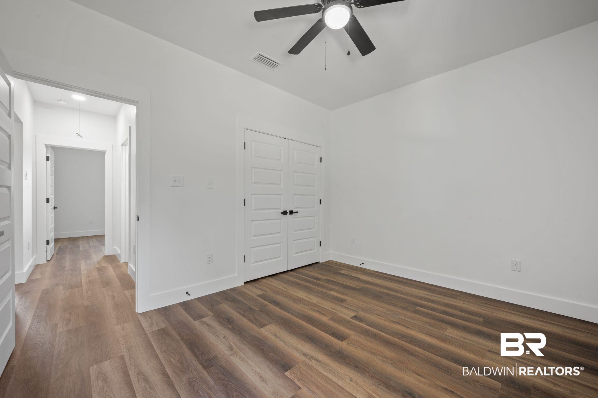 12100 Lott Road Chunchula, AL 36521 - Photo 16 of 21 Unfurnished bedroom featuring a closet, hardwood / wood-style flooring, and ceiling fan