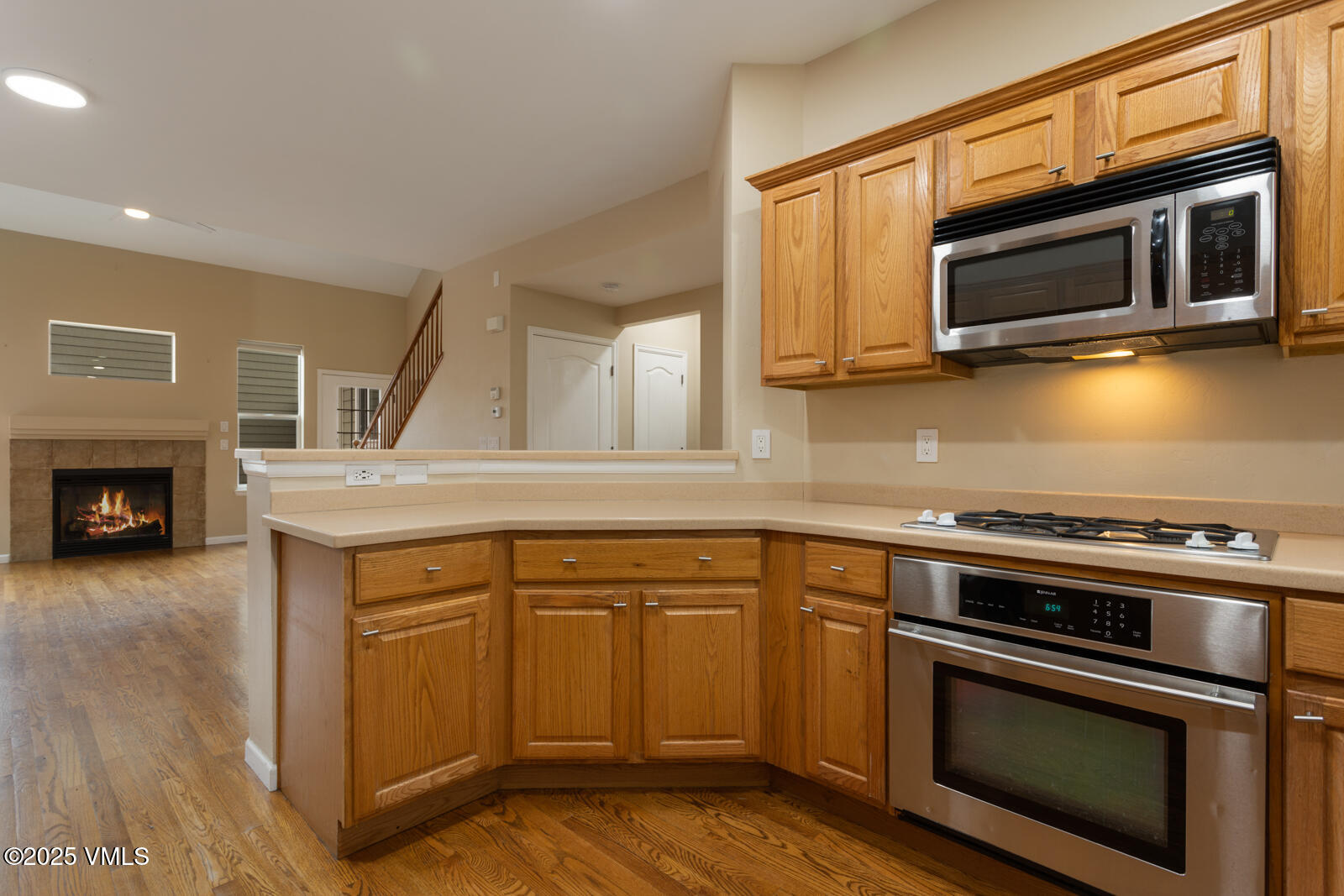 260 Longview Avenue Eagle, CO 81631 - Photo 3 of 34 a kitchen with granite countertop a stove top oven a sink and dishwasher a oven with wooden floors