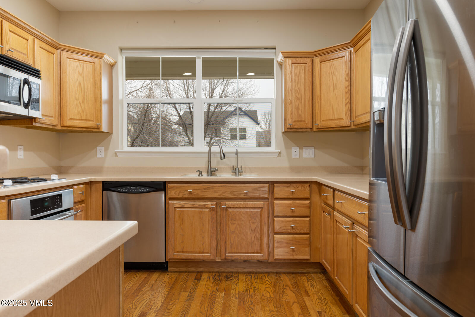 260 Longview Avenue Eagle, CO 81631 - Photo 6 of 34 a kitchen with a refrigerator a sink and cabinets