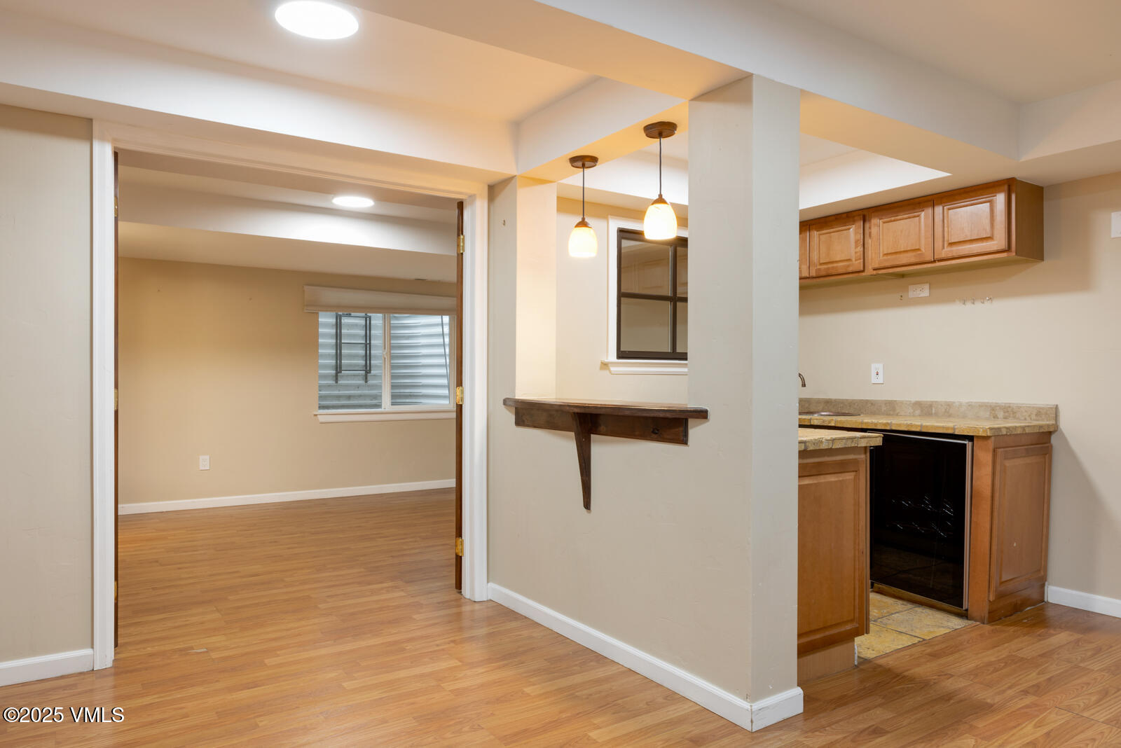 260 Longview Avenue Eagle, CO 81631 - Photo 9 of 34 a view of a hallway with wooden floor and a living room