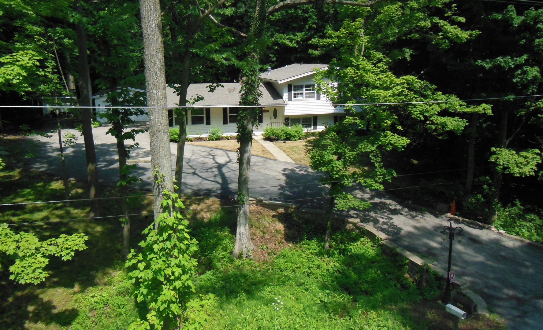 4N150 Thorntree Road St. Charles, IL 60174 - Photo 1 of 29 a view of a house with a small yard and large trees