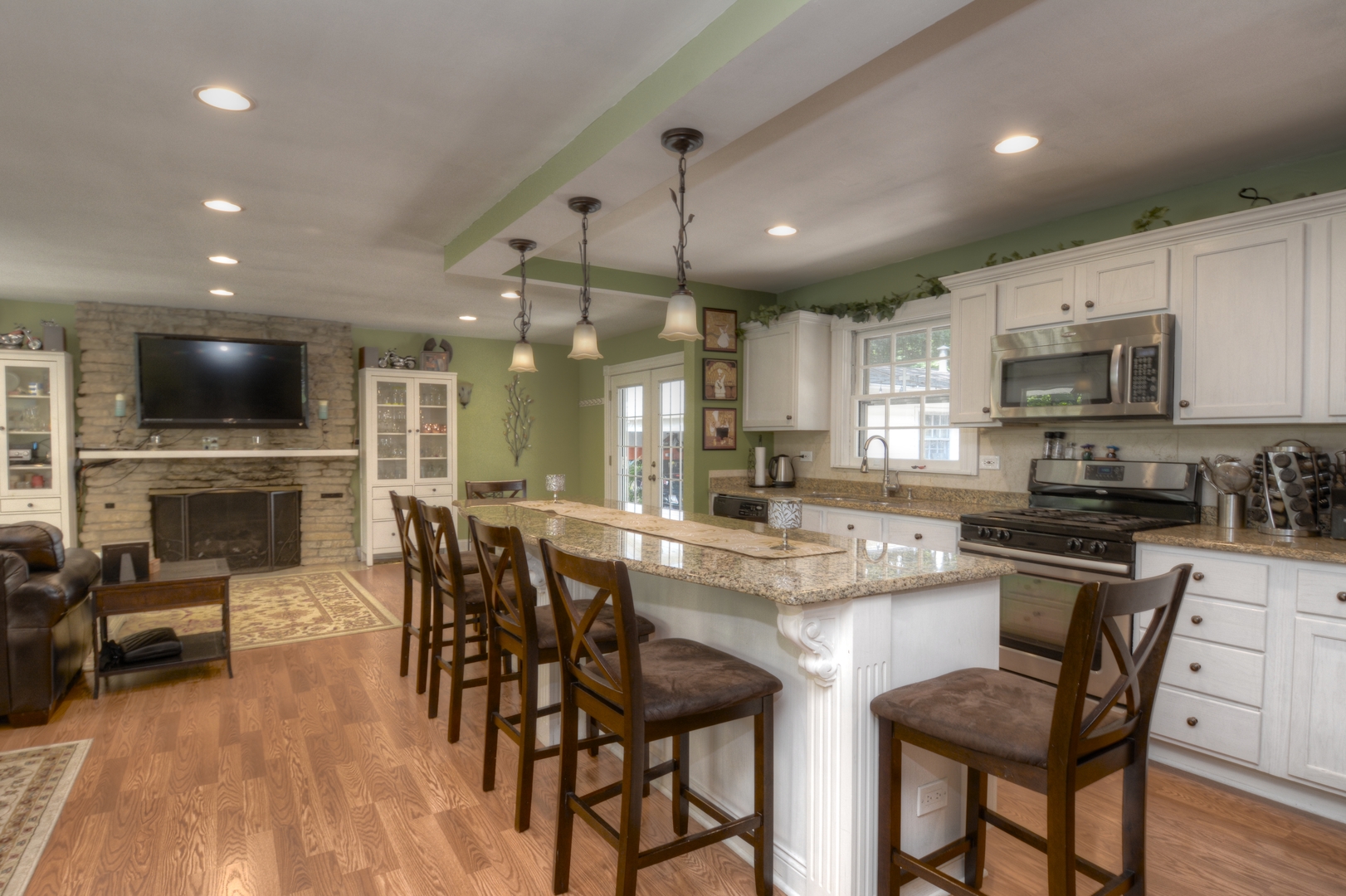 4N150 Thorntree Road St. Charles, IL 60174 - Photo 3 of 29 a kitchen with stainless steel appliances kitchen island granite countertop a stove a sink a microwave a dining table and chairs