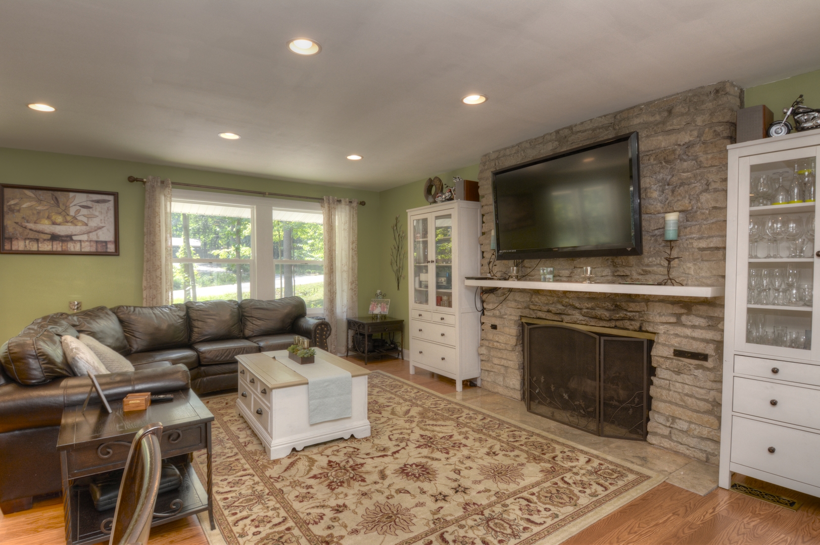 4N150 Thorntree Road St. Charles, IL 60174 - Photo 5 of 29 a living room with furniture a flat screen tv and a fireplace