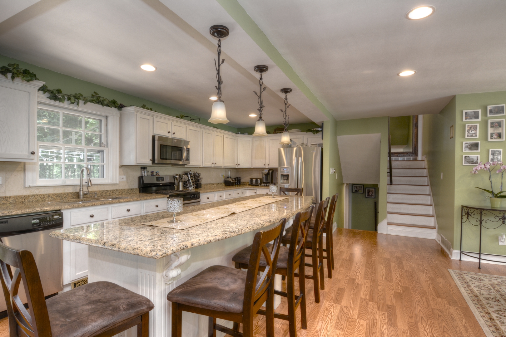 4N150 Thorntree Road St. Charles, IL 60174 - Photo 8 of 29 a kitchen with granite countertop a table chairs microwave and cabinets