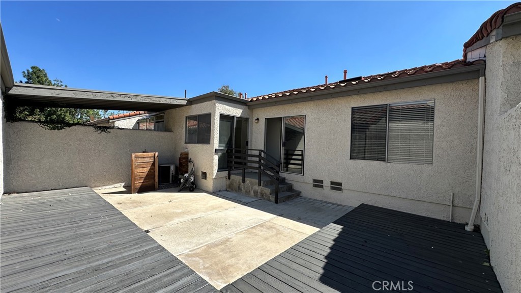 19519 Rinaldi Street, Unit 57 Porter Ranch, CA 91326 - Photo 2 of 28 a view of a house with wooden deck