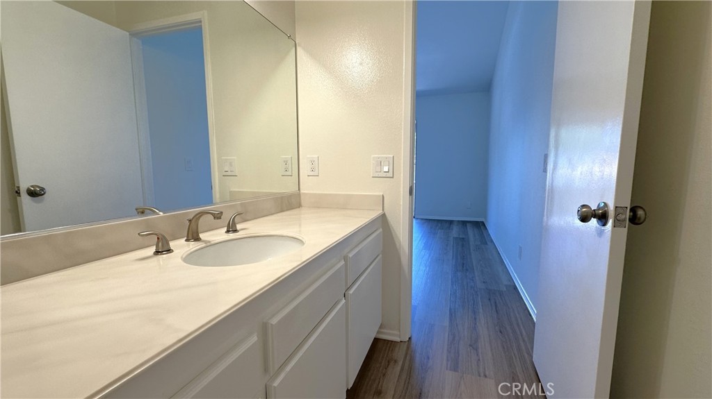 19519 Rinaldi Street, Unit 57 Porter Ranch, CA 91326 - Photo 21 of 28 a bathroom with a double vanity sink and a mirror