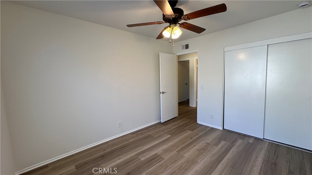 19519 Rinaldi Street, Unit 57 Porter Ranch, CA 91326 - Photo 22 of 28 an empty room with wooden floor and fan