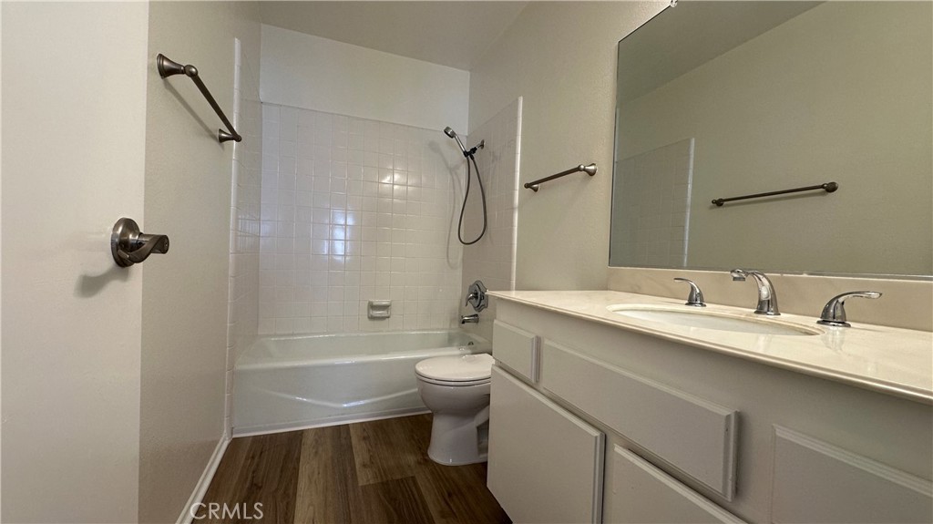 19519 Rinaldi Street, Unit 57 Porter Ranch, CA 91326 - Photo 23 of 28 a bathroom with a sink a toilet a mirror and shower