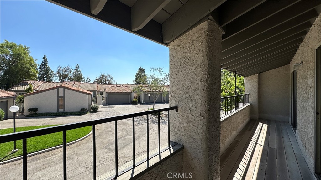 19519 Rinaldi Street, Unit 57 Porter Ranch, CA 91326 - Photo 24 of 28 a view of a balcony with two chairs and a table