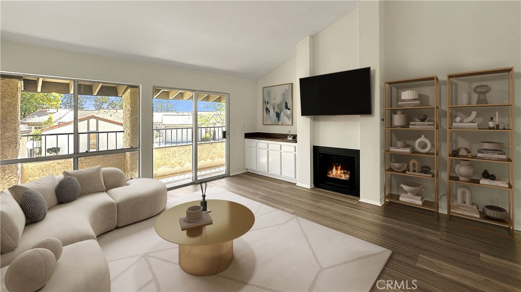 19519 Rinaldi Street, Unit 57 Porter Ranch, CA 91326 - Photo 3 of 28 a living room with furniture a flat screen tv and a fireplace