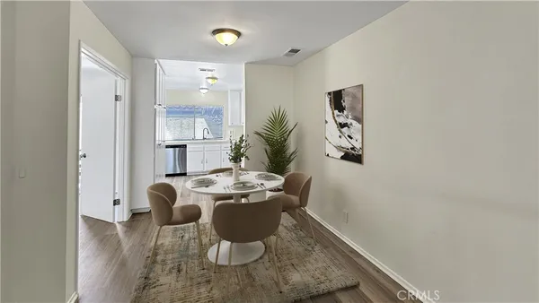 a hallway with wooden floor and windows