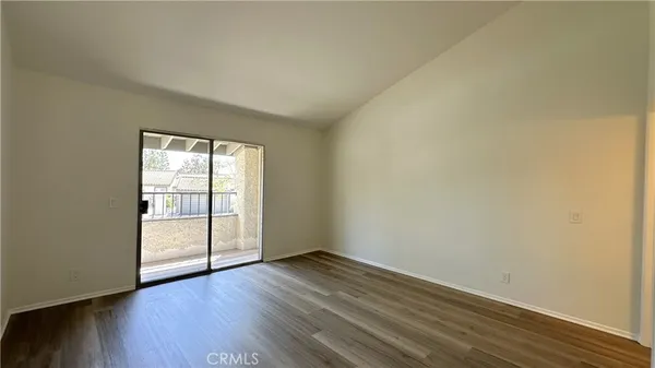 a view of a balcony with wooden floor and seating space