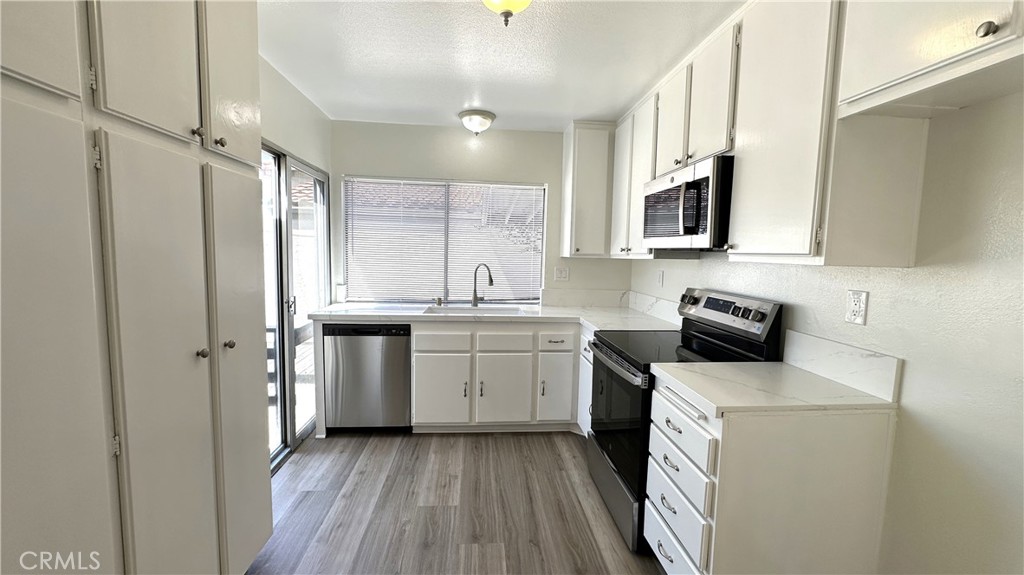 19519 Rinaldi Street, Unit 57 Porter Ranch, CA 91326 - Photo 10 of 28 a kitchen with a sink stove and refrigerator
