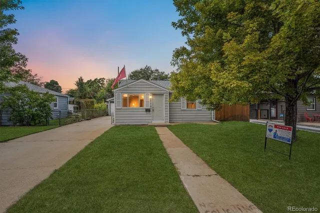 a backyard of a house with table and chairs