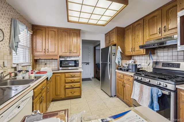 a kitchen with a stove a sink and a refrigerator