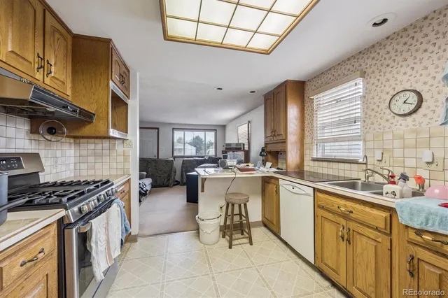 a kitchen with a sink stove and cabinets