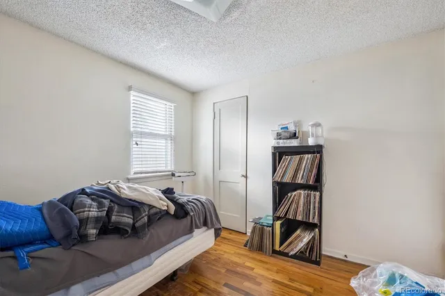 a bedroom with a bed and a book shelf