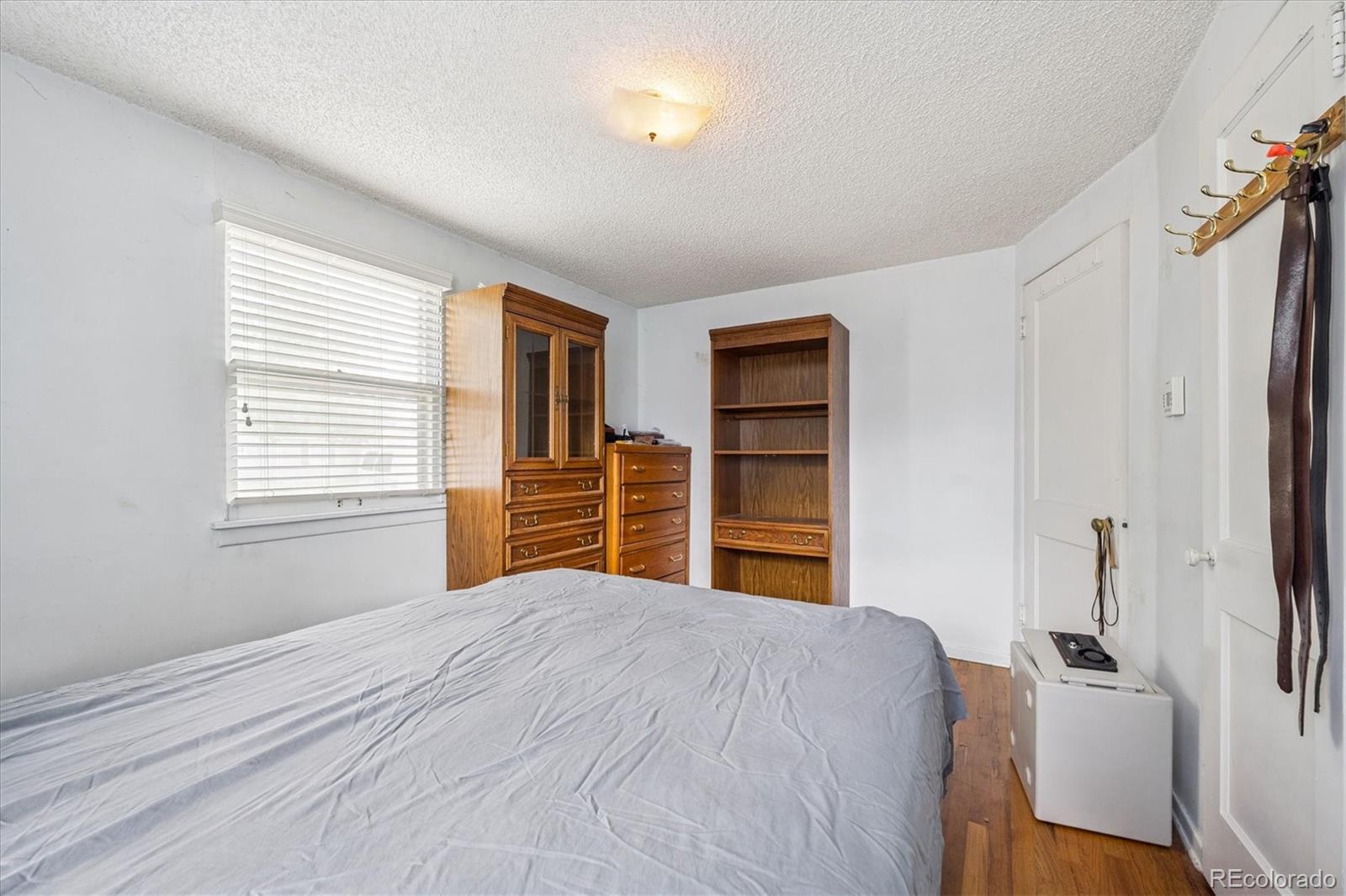 5465 Reed Court Arvada, CO 80002 - Photo 20 of 27 a bedroom with a bed and a closet
