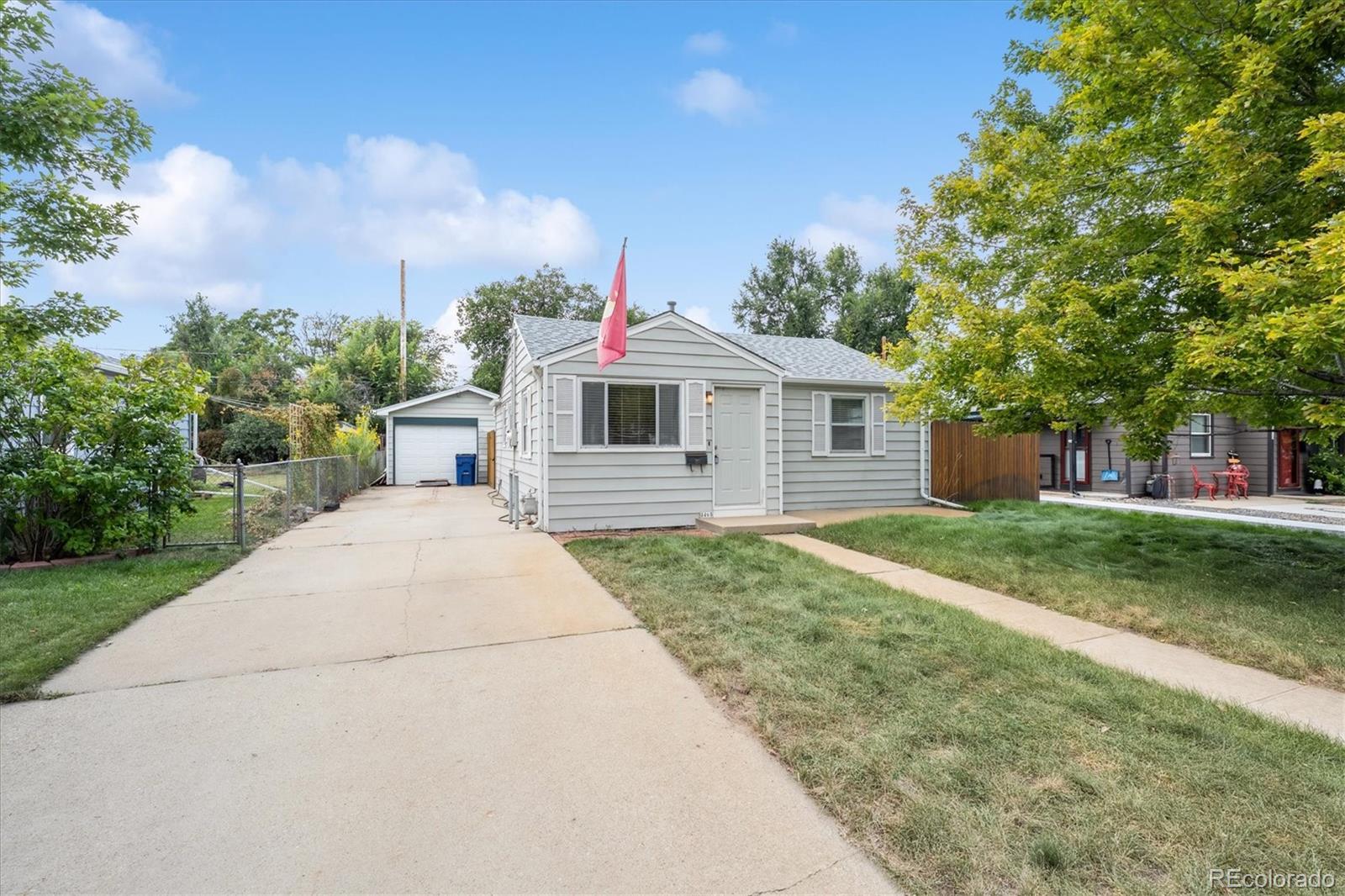 5465 Reed Court Arvada, CO 80002 - Photo 2 of 27 a front view of a house with garden