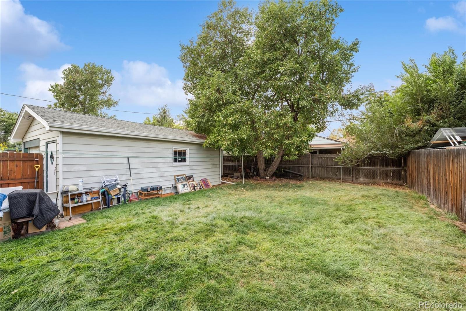 5465 Reed Court Arvada, CO 80002 - Photo 22 of 27 a backyard of a house with table and chairs