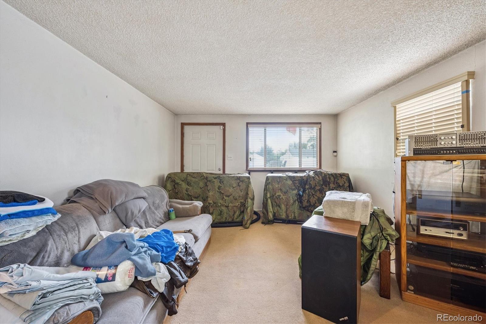 5465 Reed Court Arvada, CO 80002 - Photo 6 of 27 a living room with furniture and a window