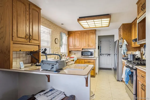 a kitchen with stainless steel appliances a sink and a refrigerator
