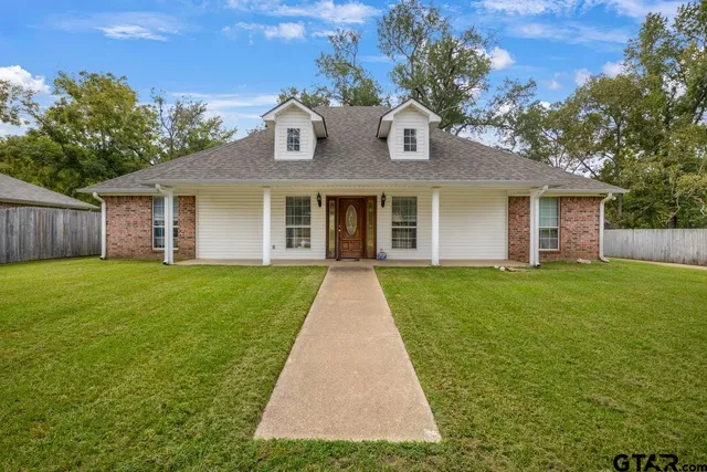 a front view of house with yard and green space