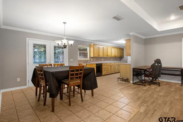 a view of dining room and kitchen with furniture window and outside view