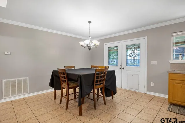 a view of a dining room with furniture and chandelier