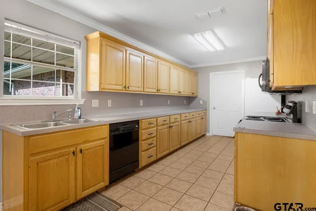 a kitchen with stainless steel appliances granite countertop a sink and cabinets