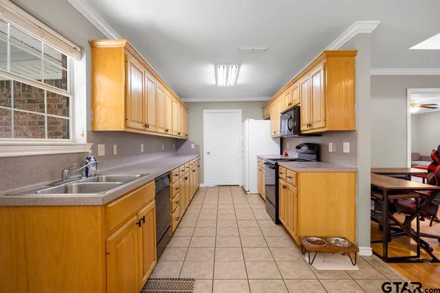 a kitchen with stainless steel appliances granite countertop a sink stove and cabinets