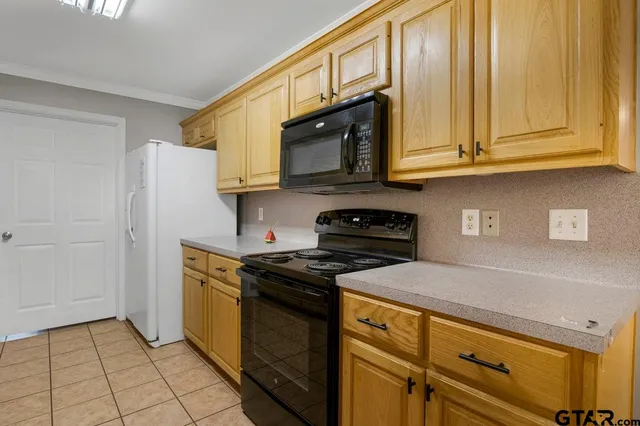 a kitchen with stainless steel appliances granite countertop a stove and a microwave