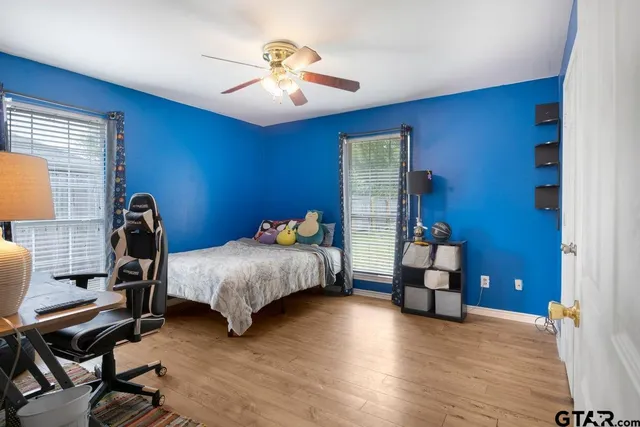 a bedroom with a bed and a chandelier