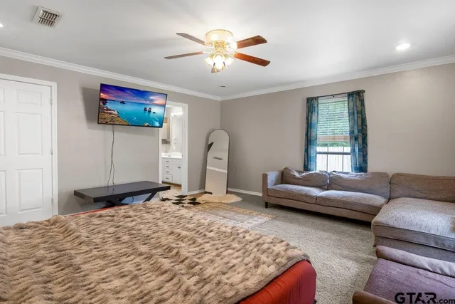 a bedroom with furniture and a window