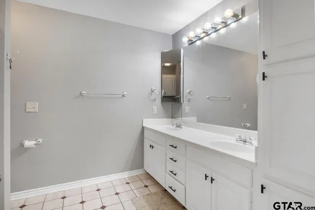 a bathroom with a double vanity sink and a mirror