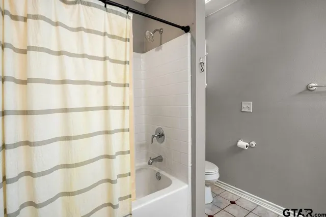 a bathroom with a bathtub and shower