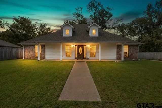 a front view of house with yard and green space