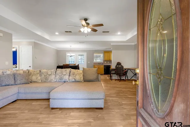 a living room with furniture and a chandelier